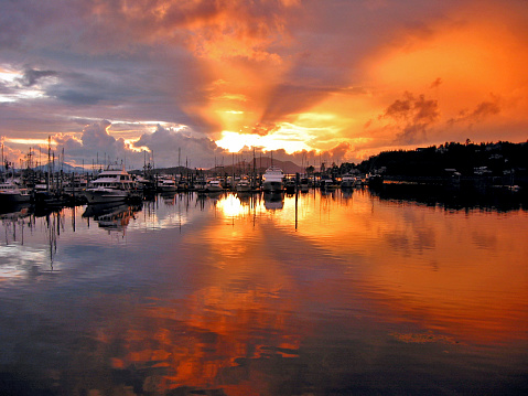 A beautiful post-storm orange sunset over Thomsen Harbor in Sitka, Alaska.