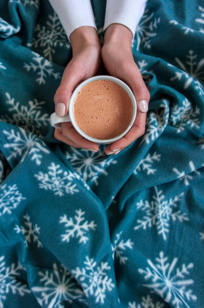 istock holding a cup of hot chocolate 1706200104