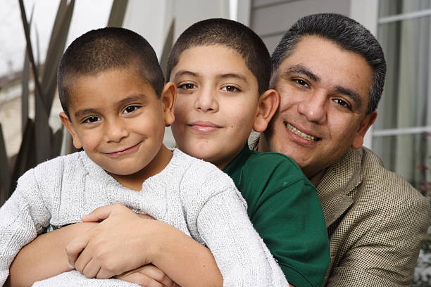 hispanic father and sons in front of house  crew cut stock pictures, royalty-free photos & images