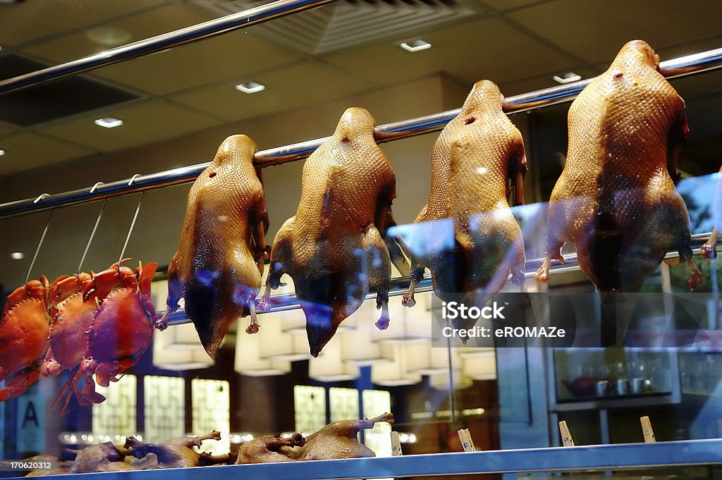 Glass display window at a foodstall , Singapore Peking ducks & raw crabs on display in a food stall in Singapore. China - East Asia Stock Photo