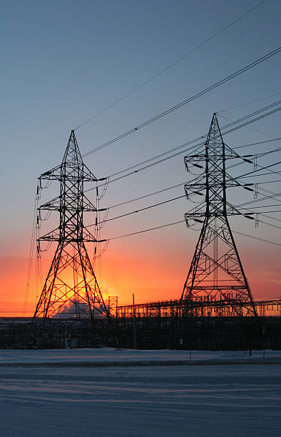 Electricity Pylon and Lines in Winter Sunset  buzbuzzer energy cable steel cable stock pictures, royalty-free photos & images