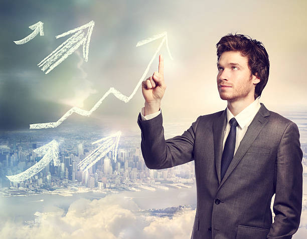 istock Businessman pointing rising arrows 170620590