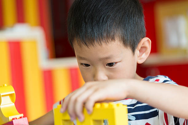 istock asian boy playing with toy 170622127