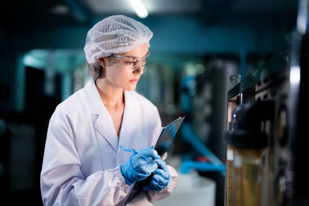 istock scientist worker checking the quality of Reverse osmosis machine system at the industrial factory. Female worker recording data at the control panel with measure pressure for recycle portable plant. 1706232000
