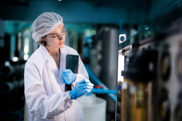 istock scientist worker checking the quality of Reverse osmosis machine system at the industrial factory. Female worker recording data at the control panel with measure pressure for recycle portable plant. 1706232526