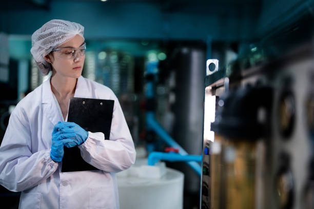 istock scientist worker checking the quality of Reverse osmosis machine system at the industrial factory. Female worker recording data at the control panel with measure pressure for recycle portable plant. 1706233148