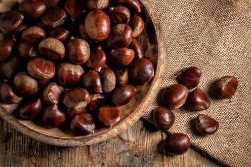 Roasted chestnuts on an old board. Selective focus.