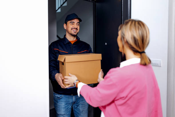istock Young delivery man at woman's doorstep 1706234323