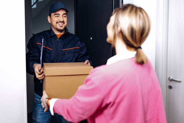 istock Woman receives package from delivery man 1706234327