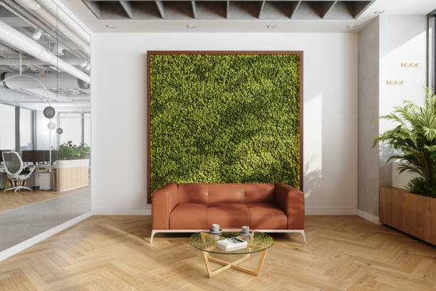 istock Waiting Area In Eco-Friendly Modern Open Plan Office With Sofa, Coffee Table And Vertical Garden 1706238595