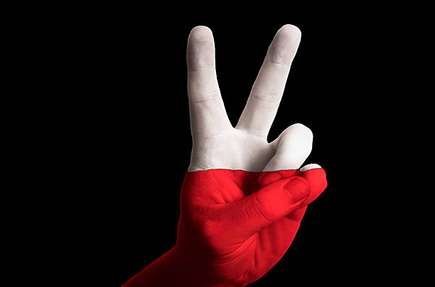 Hand with two finger up gesture in colored poland national flag as symbol of winning, victorious, excellent, - for tourism and touristic advertising, positive political, cultural, social management of country