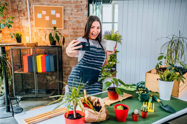 istock Woman taking a selfie with repotted plant 1706257636