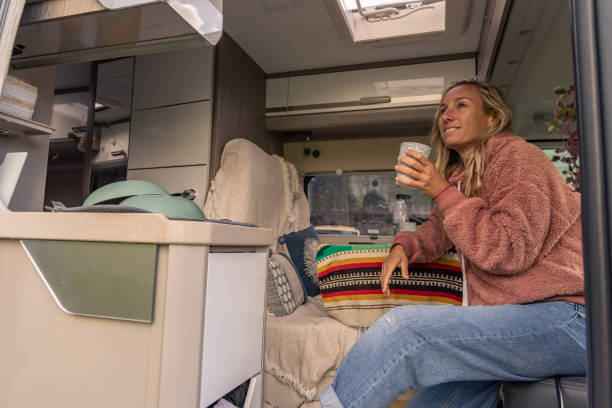 istock Woman having a drink in her camper van 1706263439