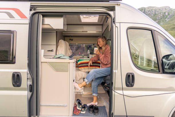 istock Woman having a drink in her camper van 1706263978