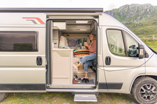 istock Woman having a drink in her camper van 1706263979