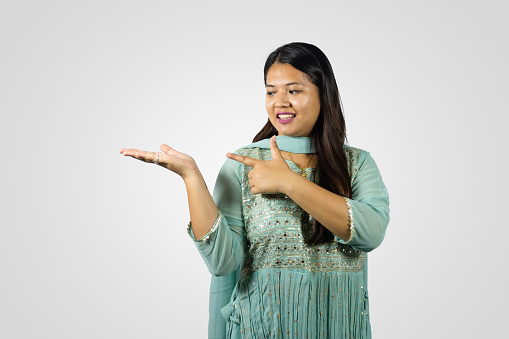 South Asian Nepalese Young Girl Smiling in a Kurthi giving gestures and Namaste