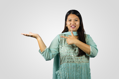 South Asian Nepalese Young Girl Smiling in a Kurthi giving gestures and Namaste