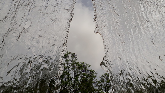 Wide stream of water falling in a semi-translucent park