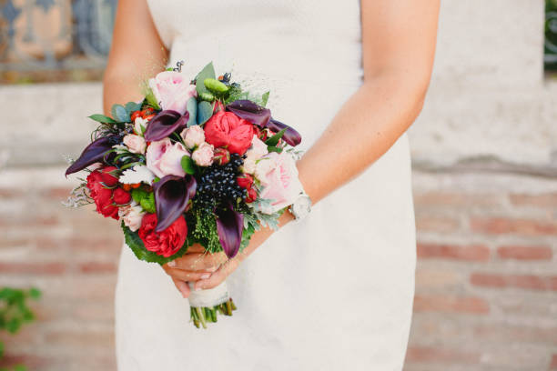 istock Bridal bouquet held by her with her hands at her wedding 1706279008