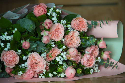 Beautiful flower bouquet on the wooden table background