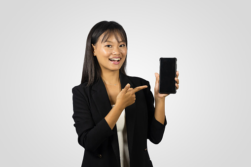 Beautiful Asian Businesswoman with her device mobile laptopgiving pose and gestures