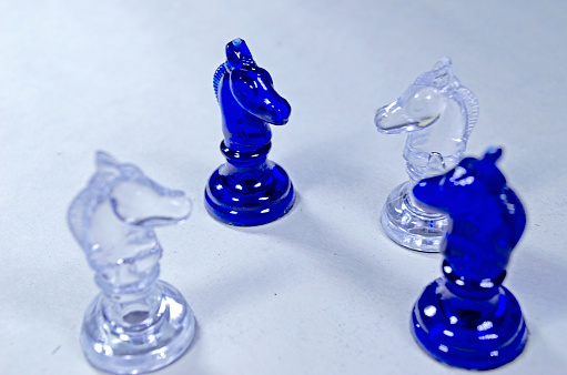 Chess pieces on a white background. Blue and white chess figures.