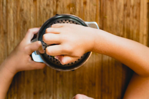istock Child squeezing the juice of a lemon. 1706325254