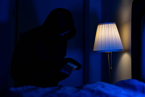 istock Female thief steals money from the bedside table. 1706325295