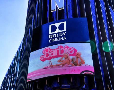 Promotional digital screen banner for Margot Robbie and Ryan Gosling's Barbie film at the iconic Odeon Cinema in Leicester Square, London.

In this photo, ODEON Luxe West End, an iconic movie theatre of London and the Londoner Hotel building's frontal facade is seen. The American director Greta Gerwig's 