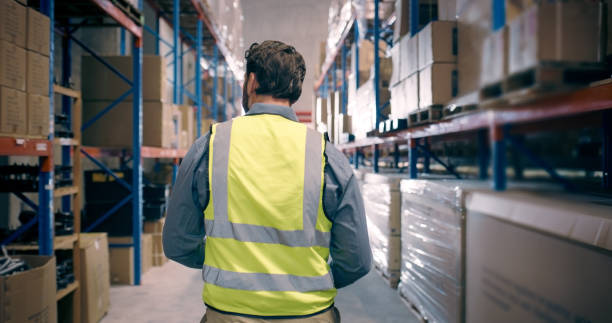istock Man at warehouse, inventory management and inspection, logistics with distribution and back view. Storage, supply chain and shipping industry, check stock or product with cargo, package and review 1706330825