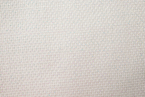 white canvas structure with metallic thread insertions, abstract empty backdrop