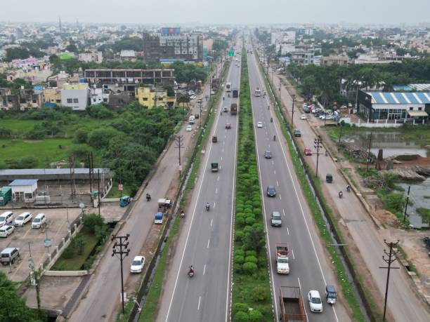 istock Road and a highway run through a sprawling metropolis 1706356240