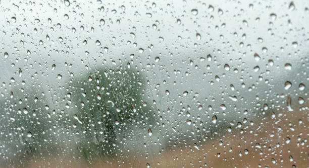 istock Mesmerizing Raindrops on Glass: Abstract Background with Subtle Landscape Hints 1706357304