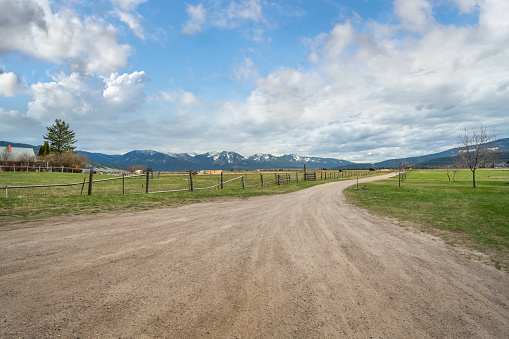 empty dirt beach with traces against Canadian Rockies, AB, Canada.