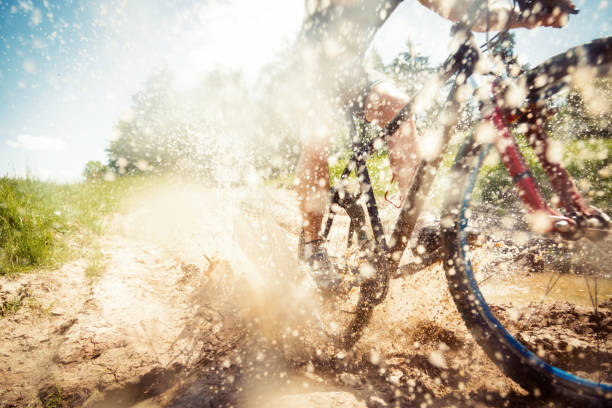 istock mountain biker riding through a dirty puddle 170639475