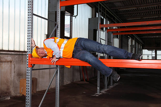 Construction worker sleeping on the job Construction worker sleeping on the job,wearing hardhat, in warehouse. lazy construction laborer stock pictures, royalty-free photos & images