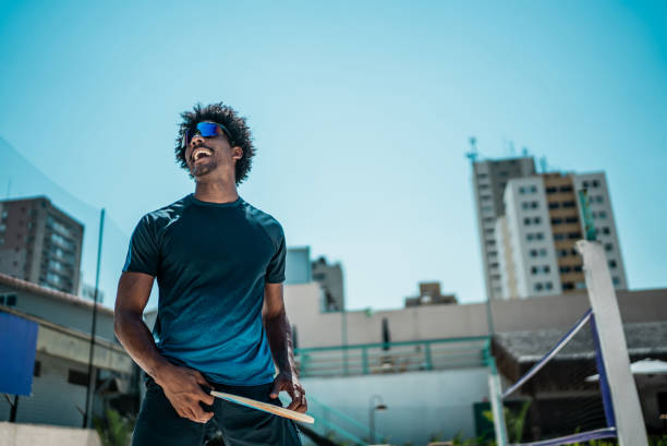Young man playing beach tennis at court