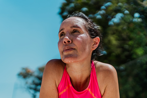 Tired mature woman sweating during sports activity