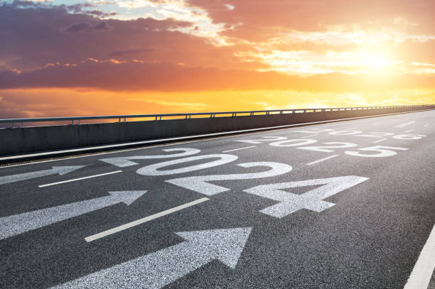 New year 2024, 2025 and 2026 with arrow sign written on highway  at sunrise stock photo