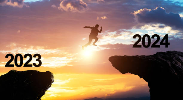 istock Single businessman jumping from 2023 cliff to 2024 1706408091