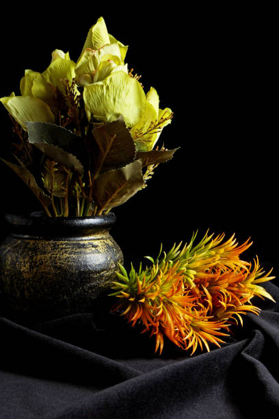 istock artificial flowers in a vase on a black background 1706415944