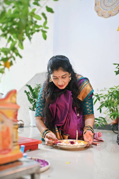 istock Woman decorating the pooja plate for Gauri pooja 1706417033