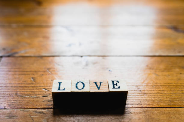 Word love on wooden background and copy space