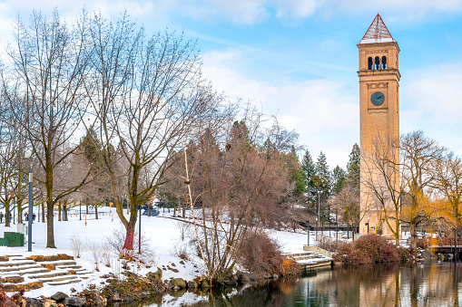 The Spokane Clock Tower and Pavilion along the Spokane river in public Riverfront Park, downtown Washington, under fresh snow at winter in the downtown district of Spokane, Washington, USA
