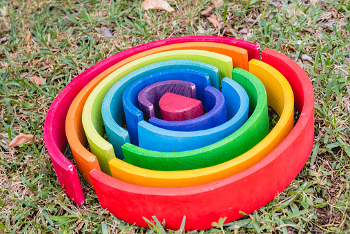 Waldorf toy rainbow on the grass.
