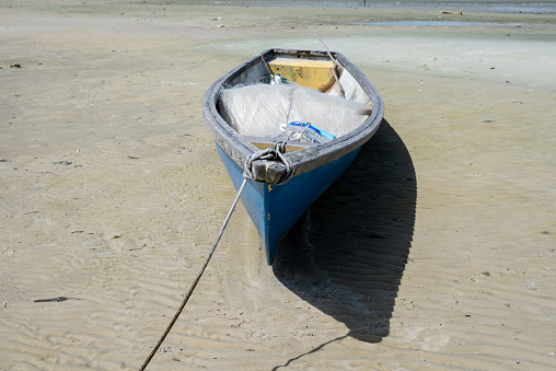 Red fishing rowboat tied up on beach , Moaña harbor, Morrazo peninsula, Rías Baixas, Pontevedra province, Galicia, Spain.