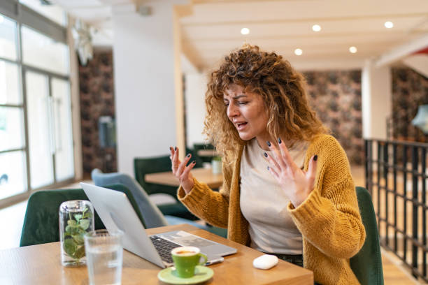 istock Angry young woman having video call, screaming and gesturing. 1706463557