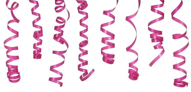 Photo of Curled pink ribbons on a white background