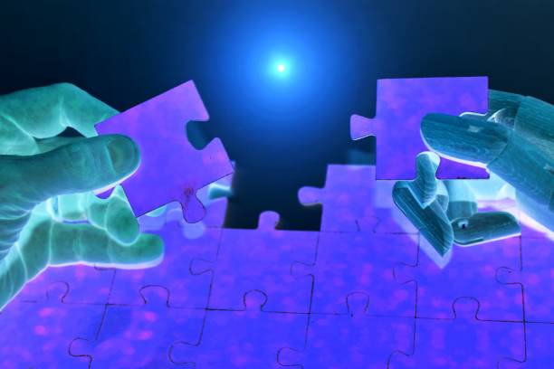 istock Close-up Of Robot And Human Hand Holding Jigsaw Puzzle 1706489740
