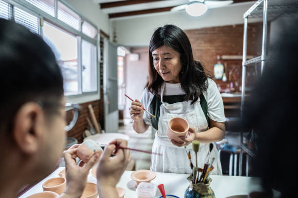 istock Teacher teaching to paint in a ceramics workshop 1706498076